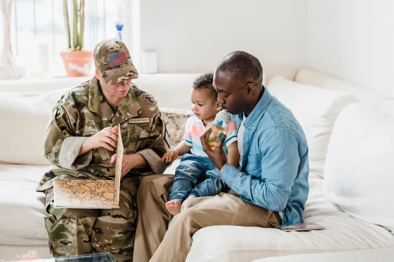 Soldier bonding with family at home, sharing a story with child on a cozy couch