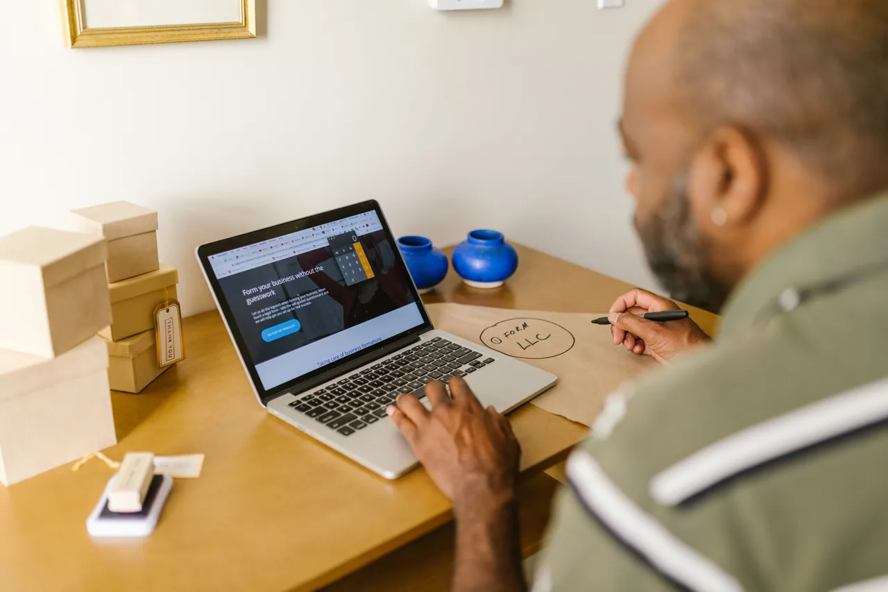 Entrepreneur at a desk using a laptop for business planning. Ideal for tech and startup themes