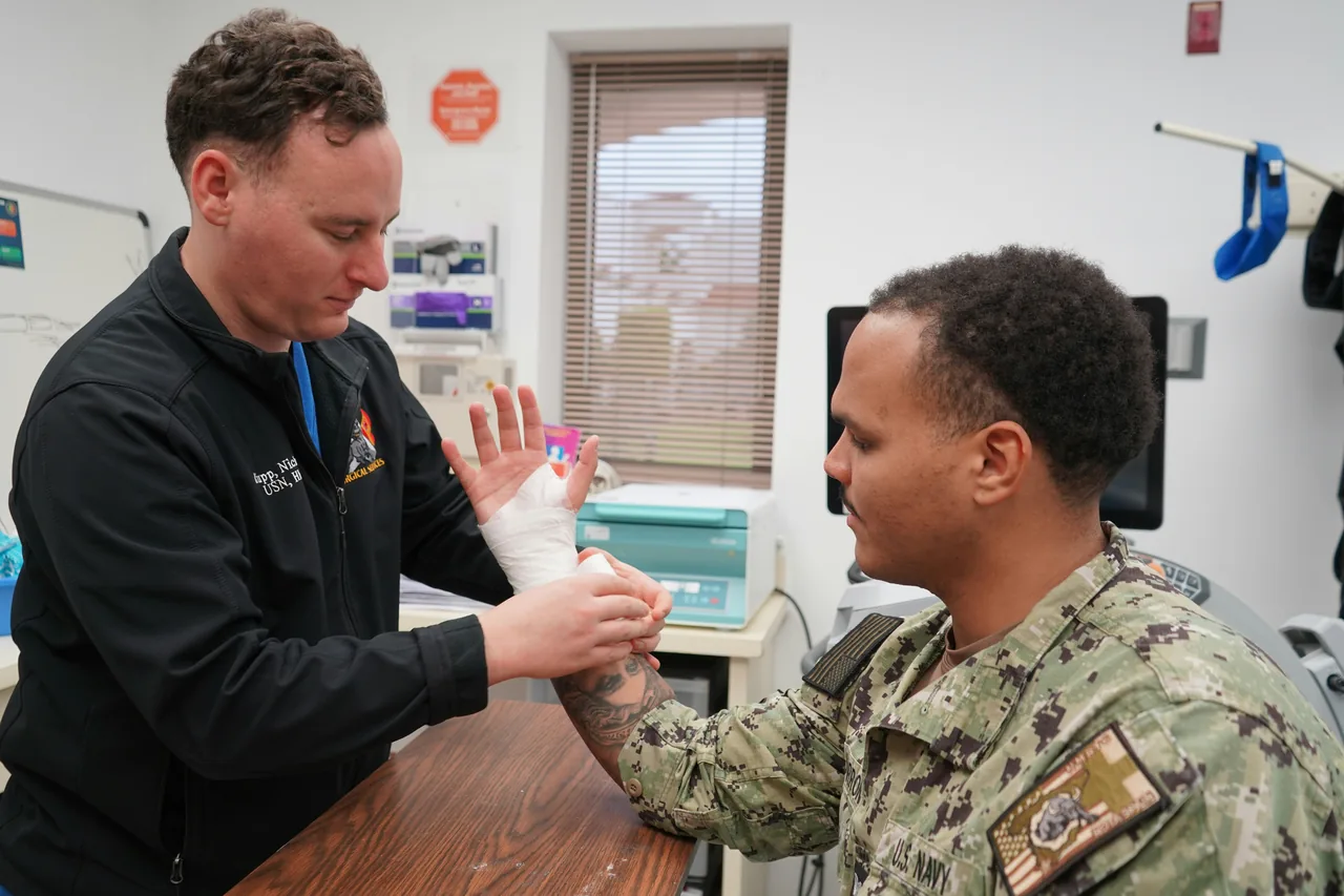 Medical professional wraps a patient's injured hand